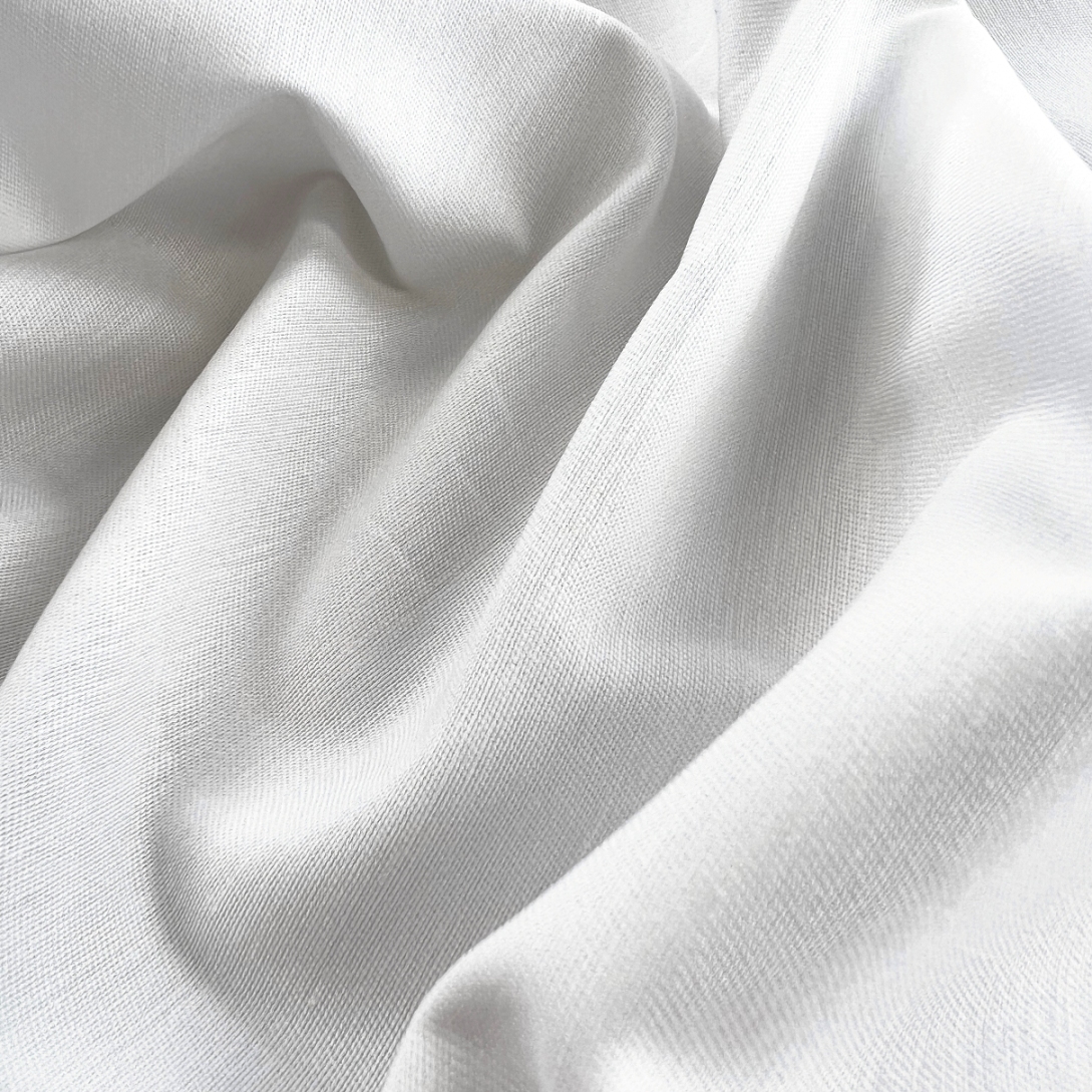 https://www.croftmill.co.uk/images/pictures/00-2023/02-february-2023/plain_white_cotton_lycra_drill_dress_trousering_fabric_cu.jpg?v=94847b84