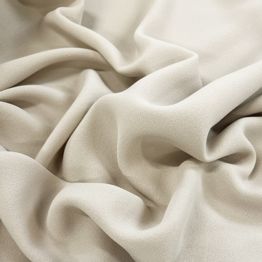 https://www.croftmill.co.uk/images/pictures/00-2023/04-april-2023/cream_triple_crepe_polyester_dress_fabric_stone_cu.jpg?v=77b3deb7