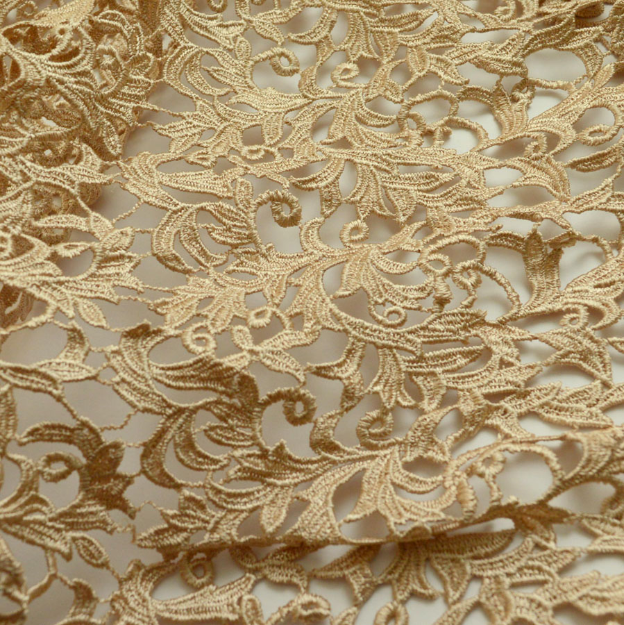 Polyester guipure nude lace fabric.